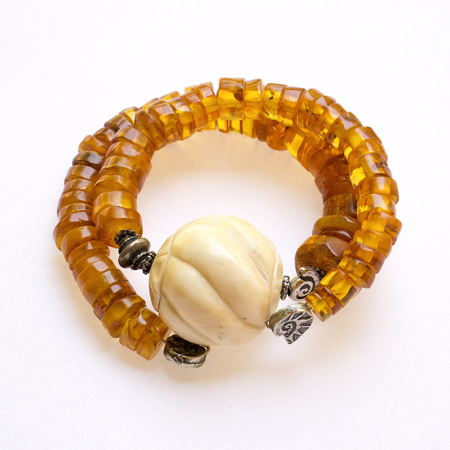 Bracelet made of solid Baltic amber, cut by hand, ivory and silver.