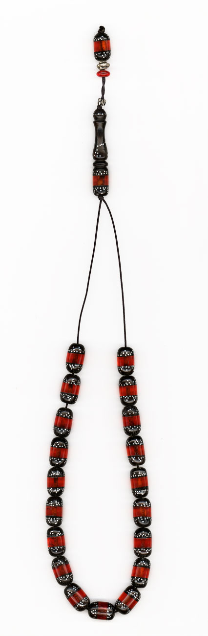 Ebony with artificial resin and silver (red).