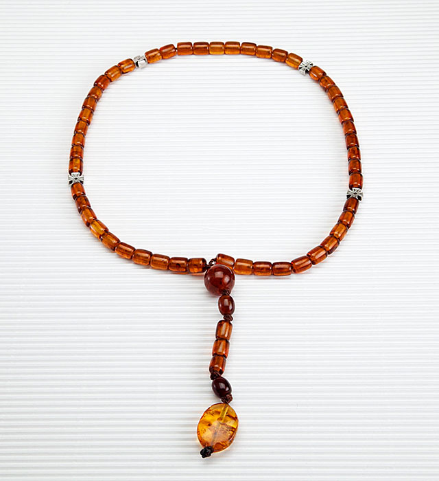 Catholic prayer object made of genuine amber from the Baltic sea and tin.